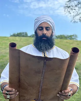 Rab Kahana Yamin Ben-EL holding an open scroll outdoors